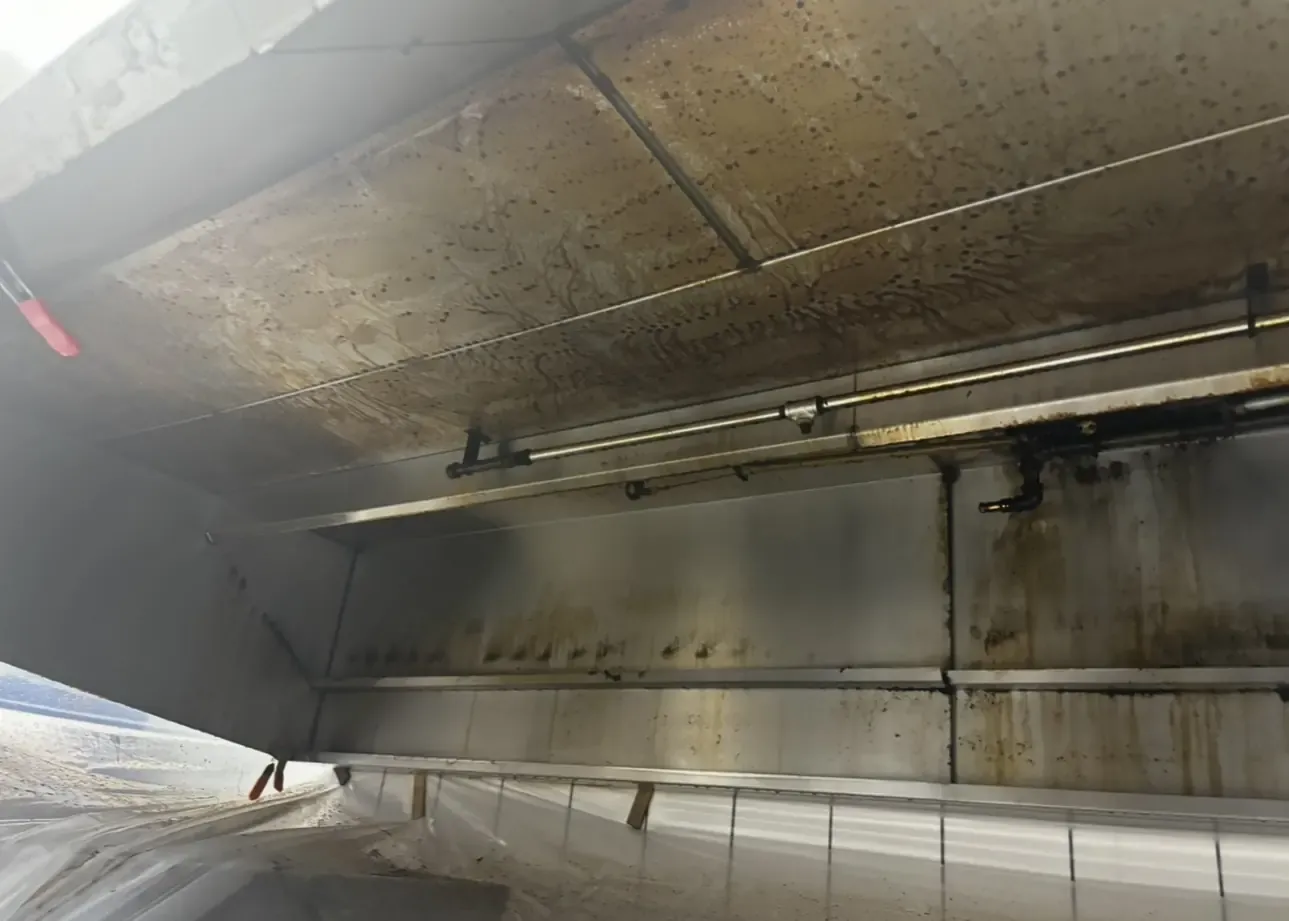 Kitchen hood canopy coated in brown grease before cleaning